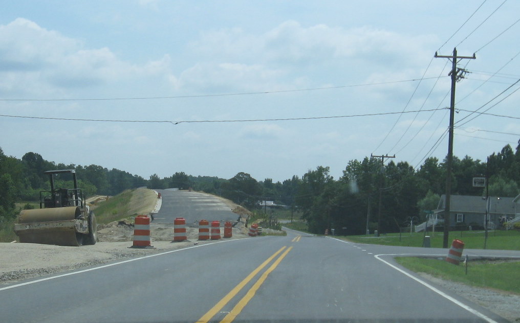 Photo of unopened NC 62 bridge showing construction on connection from the 
new bridge to existing highway, June 2009