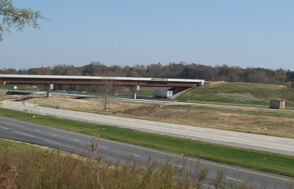 Photo of I-85/I-74 interchange under construction in Nov. 2009 showing the 
need for more walls and asphalt for the roadbed