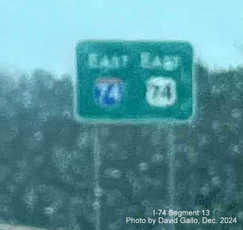 Image of newly placed East I-74/US 74 reassurance marker sign on US 74 Rockingham Bypass in the 
        rain, photo by David Gallo, December 2024