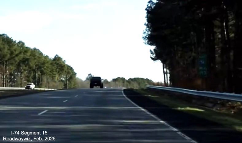 Image of newly paved shoulders on both sides of US 74 (Future I-74) East in 
	  Maxton and a premature East I-74 mile marker, screen grab from Roadwaywiz video, February 2026