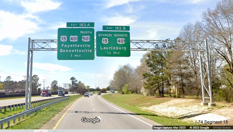 Image of new 1 mile advance overhead sign for US 15, US 401 and US 501 North exit and 1/2 Mile for
        Business 15/401 exit on US 74 (Future I-74) West in Laurinburg, Google Maps Street View, March 2023
