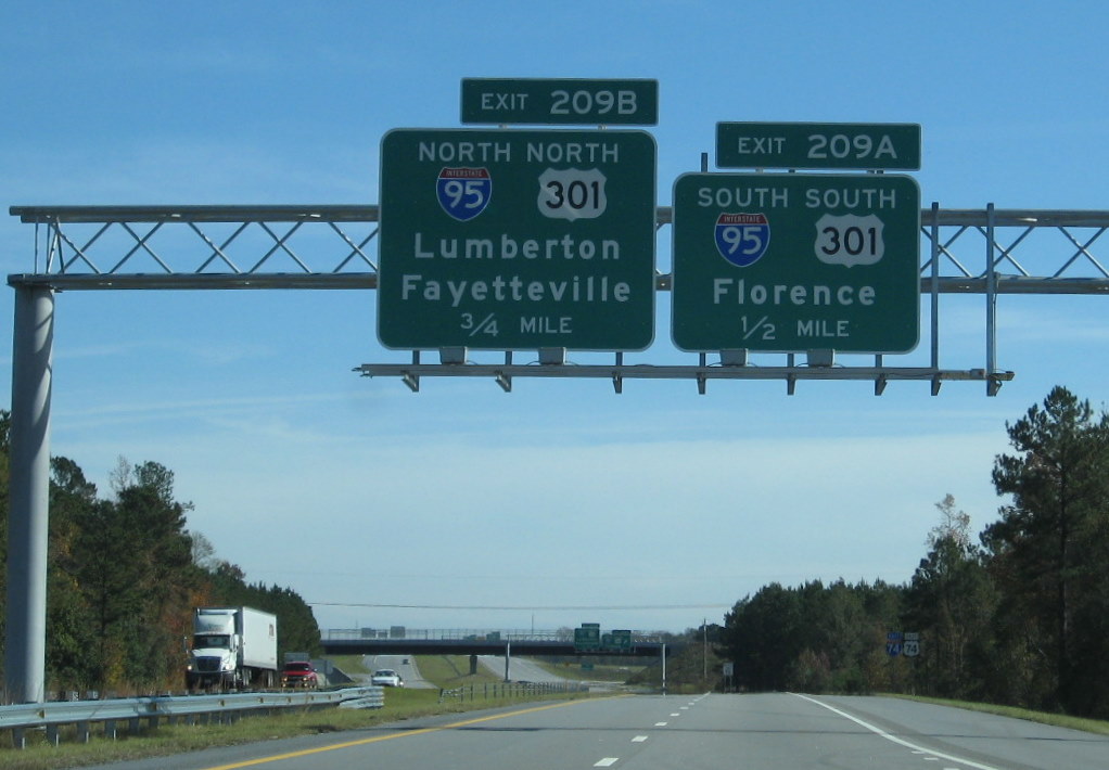 Photo of first set of overhead signs on I-74 East for I-95/US 301 exit near 
Lumberton, Nov. 2009