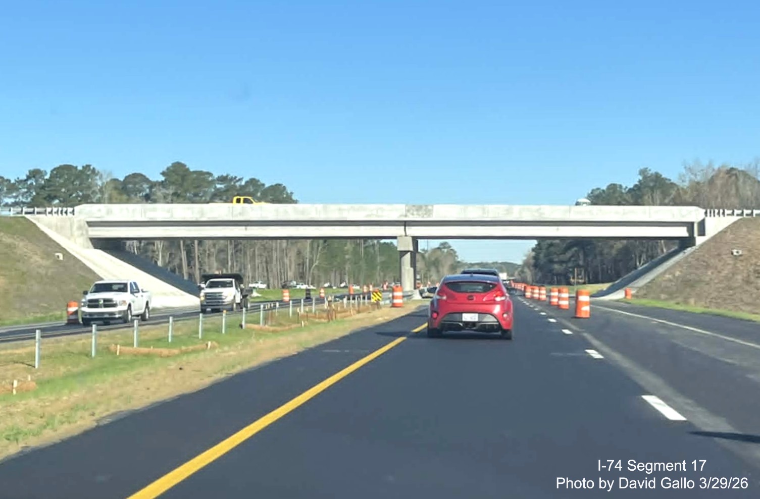 Image approaching the completed NC 72/ 130 West interchange bridge on US 74 
	  (Future I-74) East in Robeson County showing similar progress on westbound lanes, Google Maps Street View, February 2026