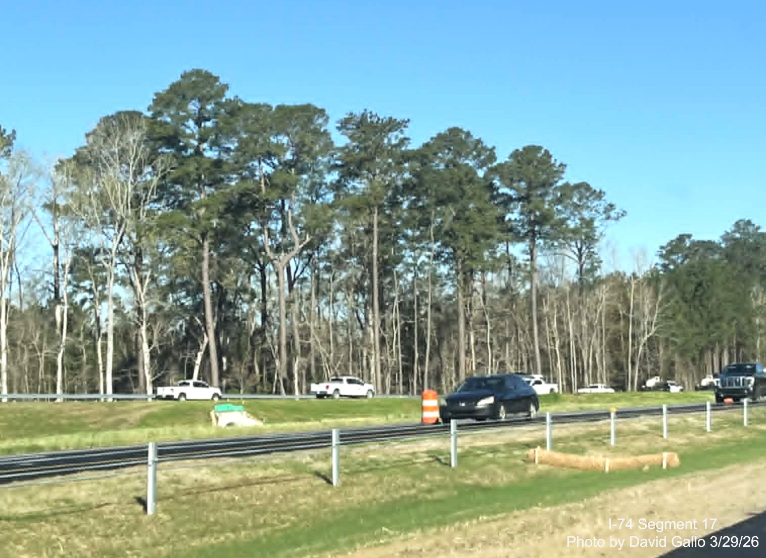 Image of the NC 72/ 130 West interchange ramp from US 74 (Future I-74) West in 
	  Robeson County showing construction vehicles using the unopened ramp. Google Maps Street View, February 2026