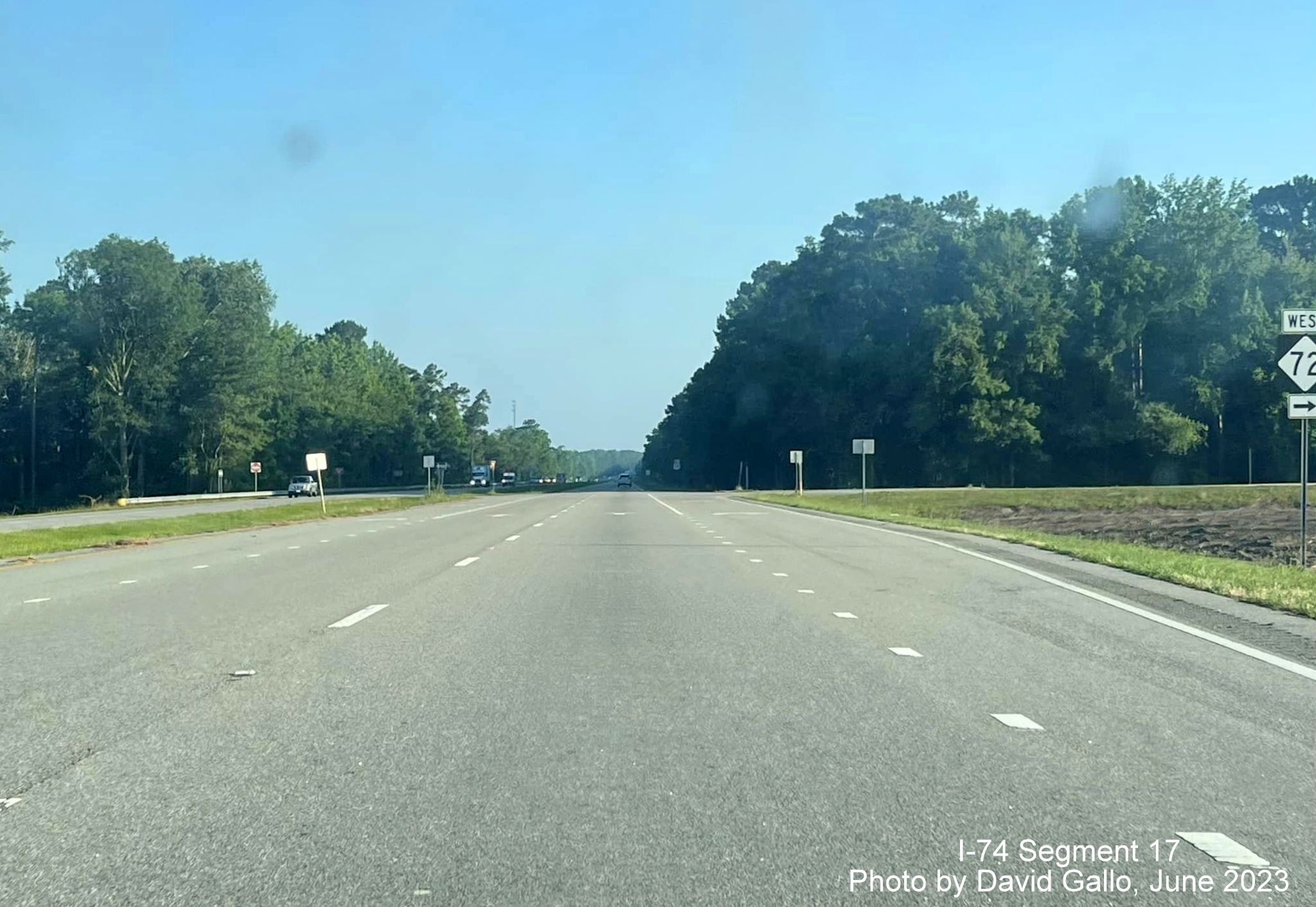 Image of NC 72 trailblazer approaching current intersection on US 74 
       (Future I-74) West, by David Gallo, June 2023