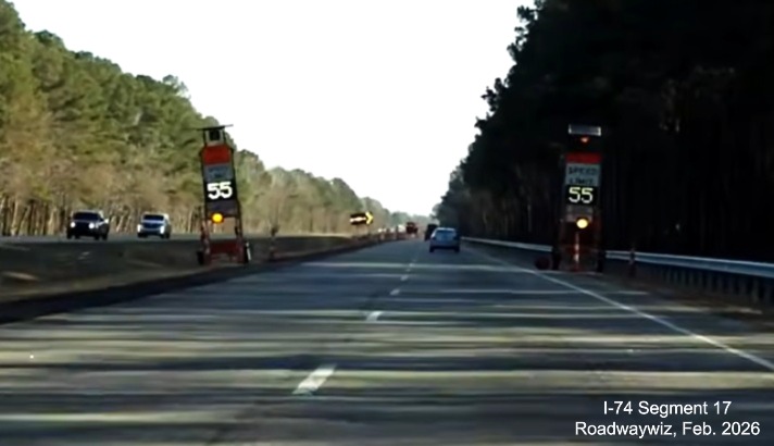 Image approaching pavement rehabilitation project work zone on US 74 (Future I-74) 
	  East in Robeson County, showing temporary variable Speed Limit signs. Google Maps Street View, February 2026