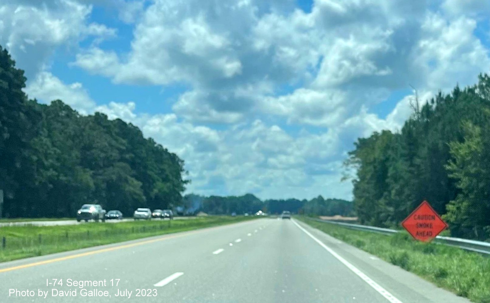 Image of Smoke Warning sign on US 74 East lanes prior to NC 130 intersection in new interchange work zone, David Gallo, 
        July 2023