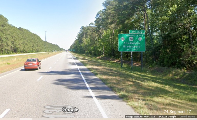 Image of ground mounted 1 mile advance sign for NC 410/Business 74/NC 130 East exit on US 74 
        (Future I-74) East in Columbus County, Google Maps Street View image, May 2022