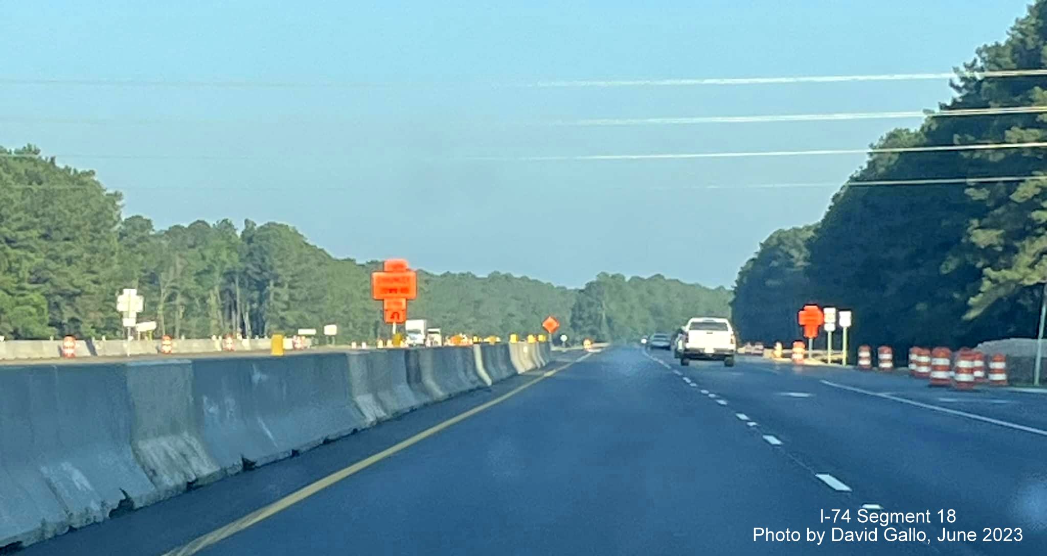 Image of median with concrete barriers prior to reduced conflict intersection turnaround after
        intersection with Chauncey Town Road on US 74/76 West in Lake Waccamaw, by David Gallo, June 2023