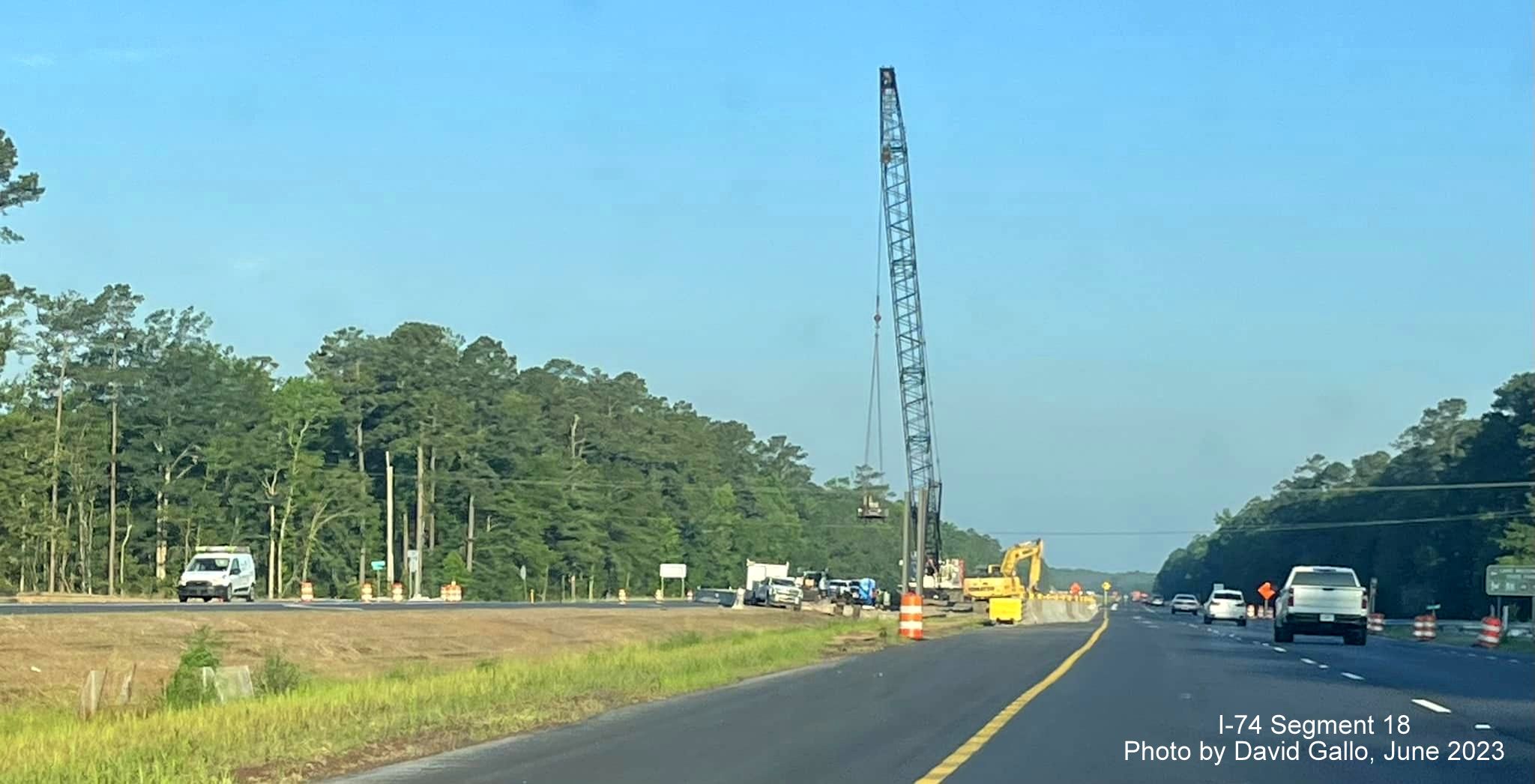 Image of construction crane in place at site of future Old Lake Road bridge seen from US 74/76 (Future I-74) East in Lake Waccamaw, David Gallo, June 2023
