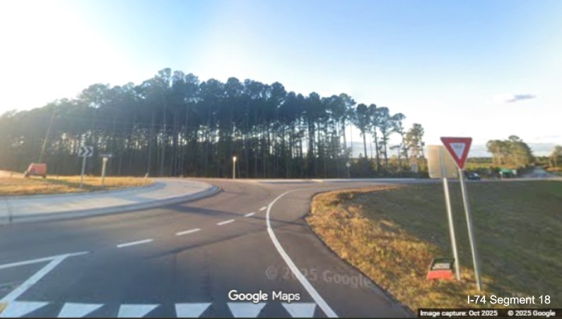 Image of completed roundabout at end of ramp from Lake Waccamaw exit on US 74/76
	  (Future I-74) West, Google Maps Street View, October 2025