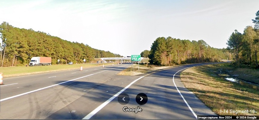 Image of recently placed gore sign for Lake Waccamaw exit on US 74/76 (Future I-74) East, Google 
        Maps Street View, November 2024