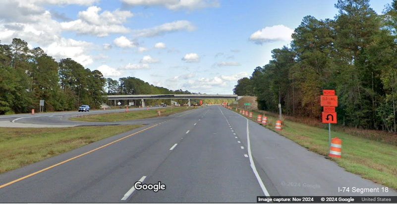 Image of approaching Old Lake Road bridge still under construction on US 74/76 (Future I-74) East, 
        Google Maps Street View, November 2024