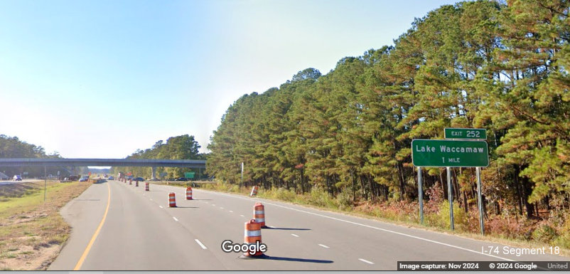 Image of 1 mile advance sign for Lake Waccamaw exit prior to Old Lake Road on US 74/76 (Future I-74)
          West, Google Maps Street View, November 2024