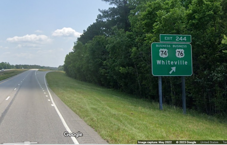 Image of ground mounted ramp sign for Business US 74/76 exit on US 74/76 (Future I-74) East in Whiteville,  Google Maps Street View, May 2022