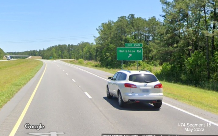 Image of ground mounted ramp sign for new Hallsboro Road exit on US 74/76 (Future I-74) East, Google Maps Street View, May 2022