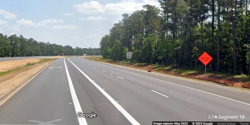 Image of reduced conflict intersection u-turn lane after the Old Lake Road intersection 
          along US 74/76 East, Google Maps Street View, May 2023