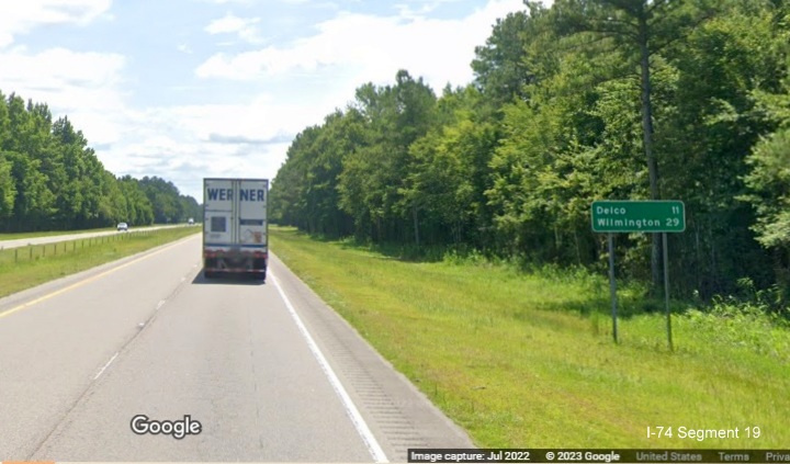 Image of ground mounted post-interchange distance sign of US 74/76
      East listing mileage as 29 miles to Wilmington, located after end of freeway section in Supply, Google Maps Street View, July 2022