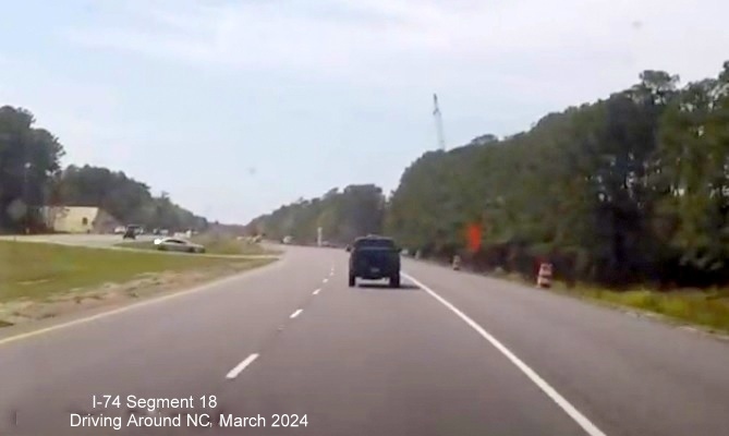 Image of US 74/76 West entering Lake Waccamaw interchange construction zone, screen shot from video by 
        Driving Around NC, April 2024