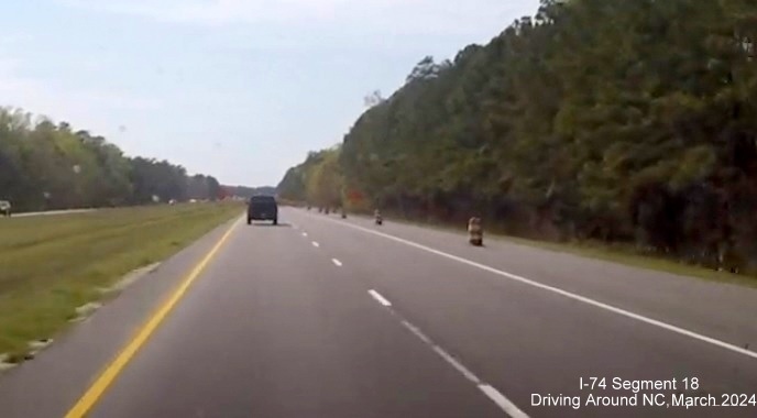 Image of US 74/76 West now with interstate standard shoulders in Lake Waccamaw interchange construction 
       zone, screen shot from video by Driving Around NC, April 2024