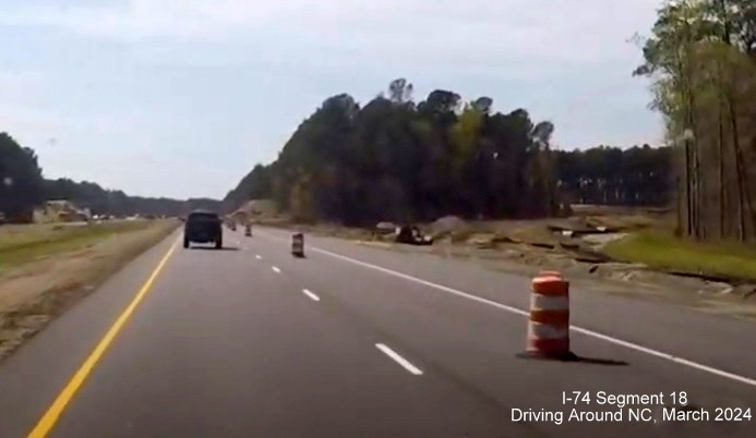 Image of future Chauncey Town Road off-ramp for Lake Waccamaw interchange, screen shot from 
        video by Driving Around NC, April 2024