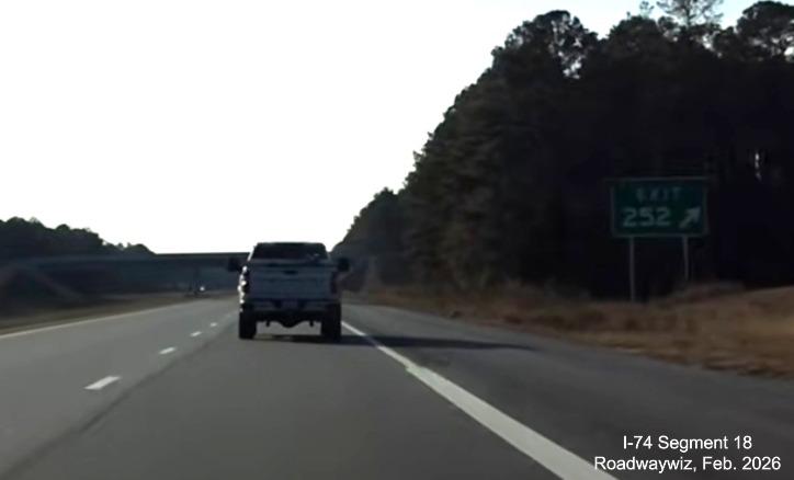 Image of gore sign for Lake Waccamaw exit at Chauncey Town Road 
	   on US 74/76 (Future I-74) West in Columbus County, Screen Grab from Roadwaywiz video, February 2026