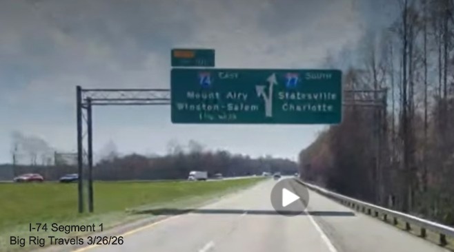 Image of unchanged exit number for I-74 East exit on overhead signage on I-77 
	  South in Surry County, Screen grab from Big Rig Travels video, March 2026