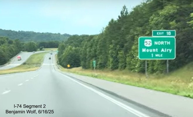 Image of renumbered exit sign for the US 52 North exit on I-74 East
		with new I-74 milepost exit number, screen grab from video by Benjamin Wolf, June 2025