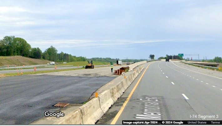 Image of site of future split of lanes between NC 74 (Future I-74) East and US 52 South lanes 
        after the NC 65 bridge in the Beltway interchange construction zone, Google Maps Street View, April 2024