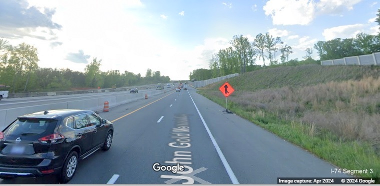 Image of traffic on US 52 North passing temporary merging traffic sign on future C/D lane from 
       Winston-Salem Northern Beltway approaching on-ramp from NC 65, Google Maps Street View, April 2024