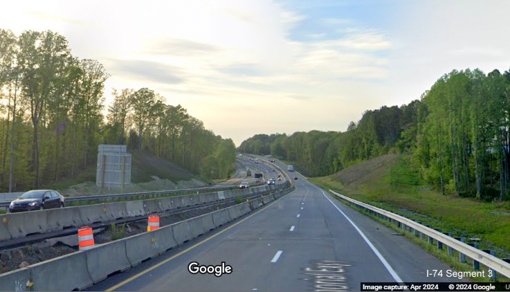 Image of traffic on US 52 North approaching the Westinghouse Road exit using 1/2 of 
        permanent lanes while other half is for current US 52 South traffic, Google Maps Street View, April 2024