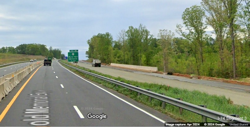 Image of one lane getting pavement on future US 52 South (I-74 East) lanes 1/2 mile prior  to
        the NC 65 exit in the Beltway interchange construction zone, Google Maps Street View, April 2024