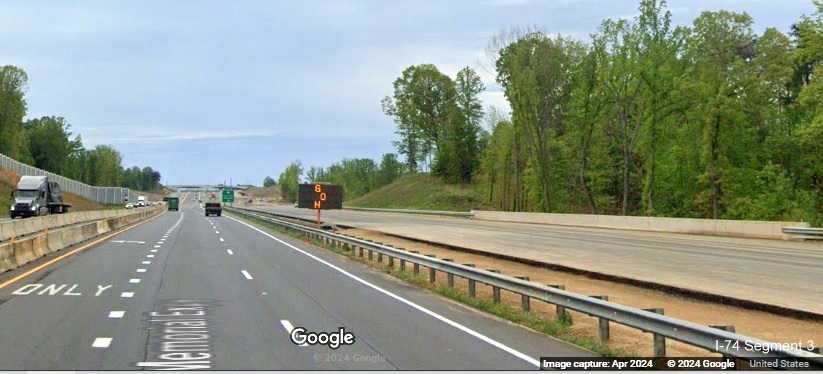 Image of paved future US 52 South (I-74 East) lanes prior to the NC 65 exit in the
        Beltway interchange construction zone, Google Maps Street View, April 2024