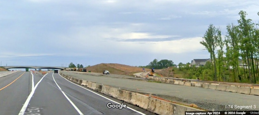 Image of graded future US 52 South (I-74 East) lanes after to the NC 65 exit in the
        Beltway interchange construction zone, Google Maps Street View, April 2024