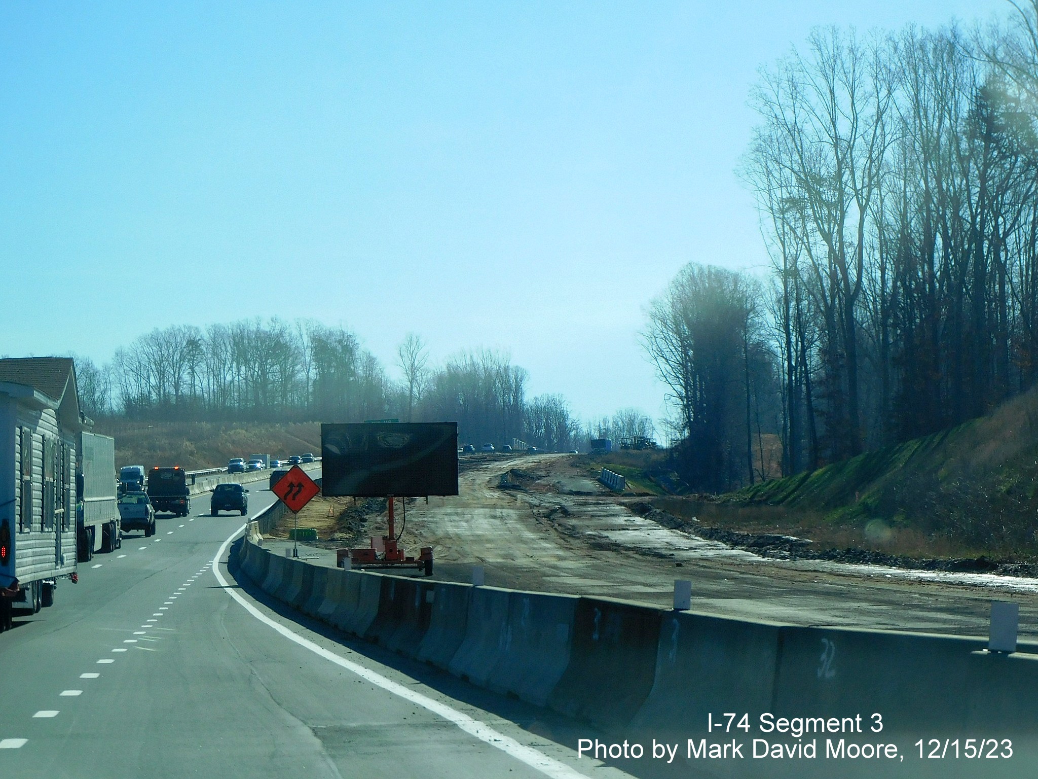Image of road widening after the Westinghouse Road exit on US 52 South (Future I-74 East) 
        heading towards the Winston-Salem Northern Beltway interchange, by Mark David Moore, December 2023