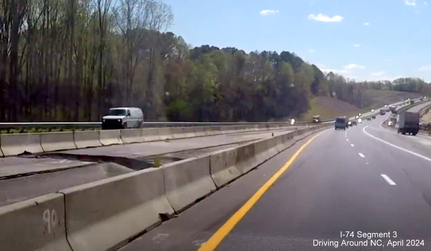 Image of median construction along US 52 near the Westinghouse Road interchange at start of 
        Winston-Salem Beltway interchange construction project, screen grab from Driving Around NC video, April 2024