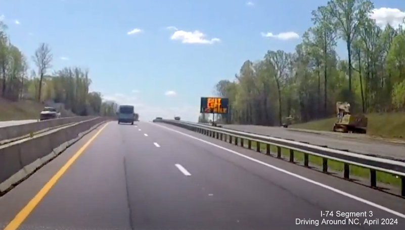 Image of VMS still being used as 1/2 Mile advance sign for NC 74 exit while permanent lanes are being 
        paved as part of Winston-Salem Beltway interchange construction project, screen grab from Driving Around NC video, April 2024