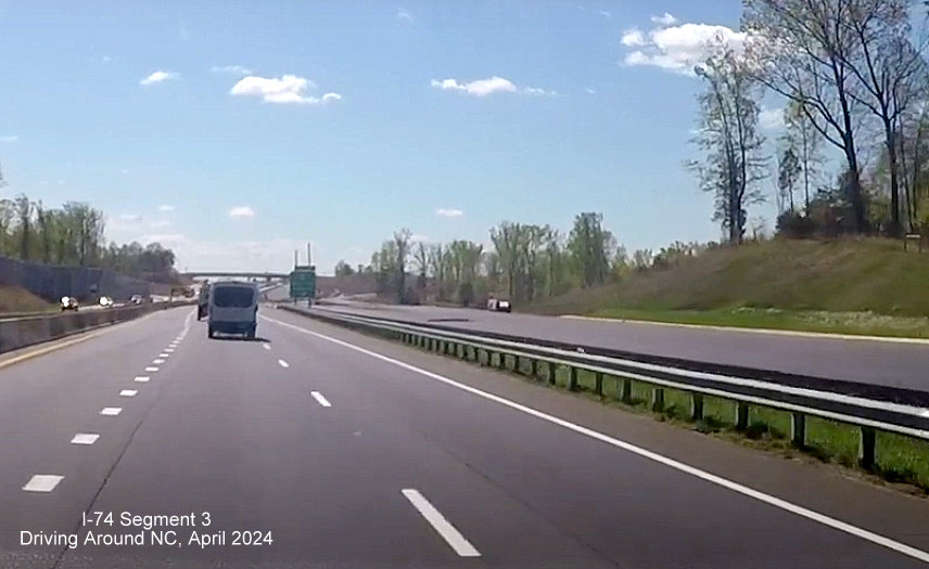 Image of new southbound lanes being paved for US 52 approaching the NC 65 interchange in the 
        Winston-Salem Beltway interchange project work zone, screen grab from Driving Around NC video, April 2024