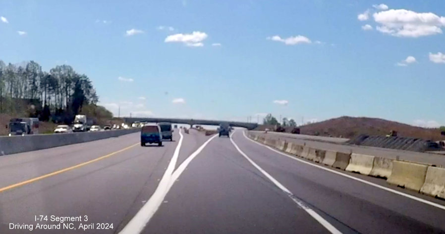 Image of current temporary split of ramps for NC 74 East and US 52 South after the NC 65 interchange 
        in the Winston-Salem Beltway interchange project work zone, screen grab from Driving Around NC video, April 2024