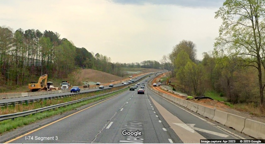 Image of start of construction zone for future I-74/Winston-Salem Beltway just beyond Westinghouse 
        Road on US 52 South (Future I-74 East), Google Maps Street View, April 2023