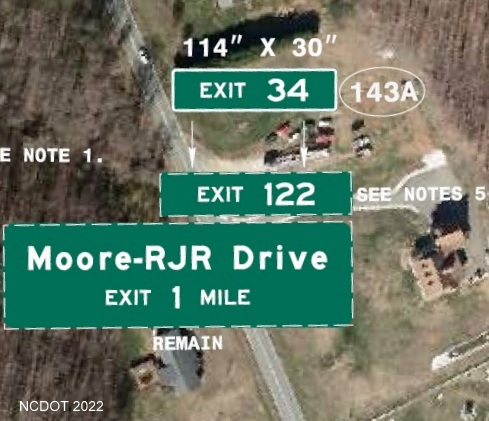 Image of plan for new exit number tab with I-74 milepost number to be placed on sign for 
        the 1 mile advance for the Moore-RJR Drive exit on US 52 in Forsyth County, NCDOT August 2022