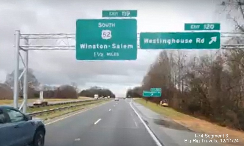 Image of newly placed overhead signs at ramp for Westinghouse Road exit on US 52 South 
       (Future I-74 East) in Rural Hall, screen grab from Big Rig Travels video, December 2024