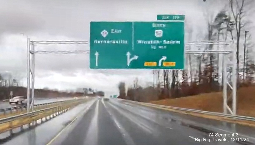 Image of newly placed 1/2 mile advance APL overhead sign for US 52 South exit on new 3-lane Future I-74 East in 
       Rural Hall, screen grab from Big Rig Travels video, December 2024