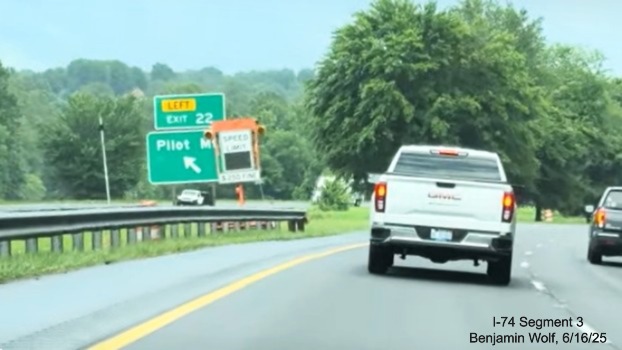 Image of renumbered left side ramp sign for the Pilot Mountain exit on 
	  US 52 South (Future I-74 East), screen grab from Benjamin Wolf video, June 2025