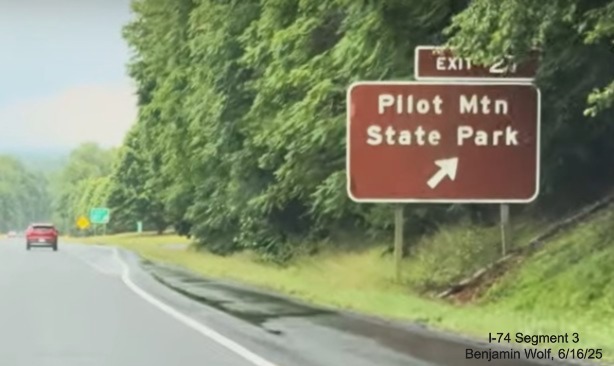 Image of renumbered brown ground mounted ramp sign for the Pilot Mountain State 
	  Park exit on US 52 South (Future I-74 East), screen grab from Benjamin Wolf video, June 2025