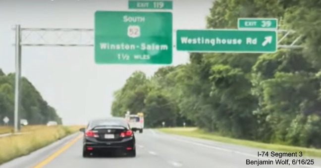 Image of overhead signs at the ramp for the Westinghouse Road
		exit on US 52 North (Future I-74 West) showing lack of new exit exit number for US 52, screen grab from video by
		Benjamin Wolf, June 2025