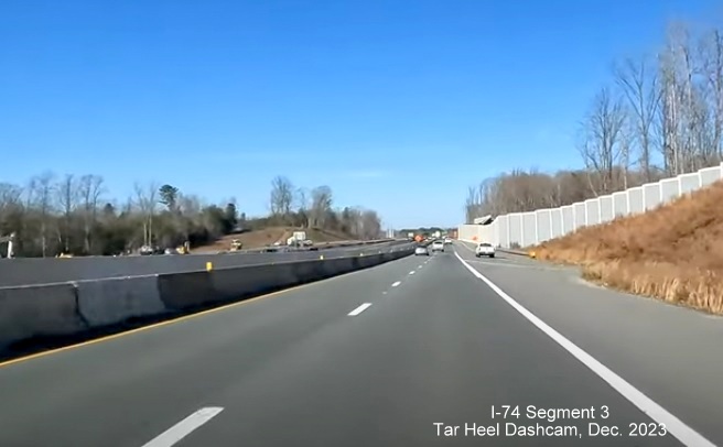 Image of driving completed lanes for US 52 North (Future I-74 West) after NC 65 exit, left lane 
       currently closed due to being used for US 52 South traffic in the distance, Tar Heel Dashcam, December 2023