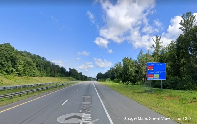 Google Maps Street View image of blue services sign for Moore-RJR Drive exit on US 52 
        North/Future I-74 West in Rural Hall, taken in June 2019