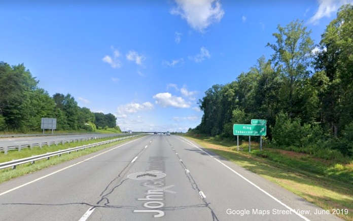Google Maps Street View image of ground mounted ramp sign for King, Tobaccoville exit on 
        US 52 North/Future I-74 West in King, taken in June 2019
