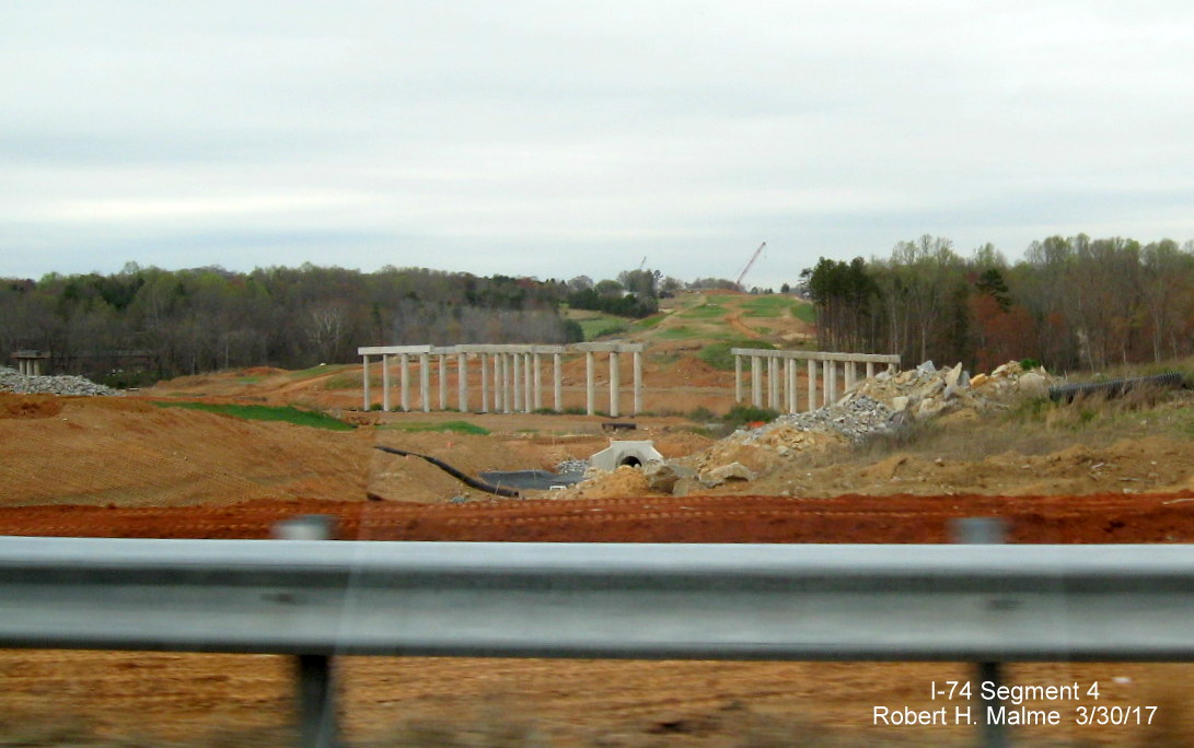 Image of view looking north along future alignment of I-74/Beltway showing bridge supports under construction